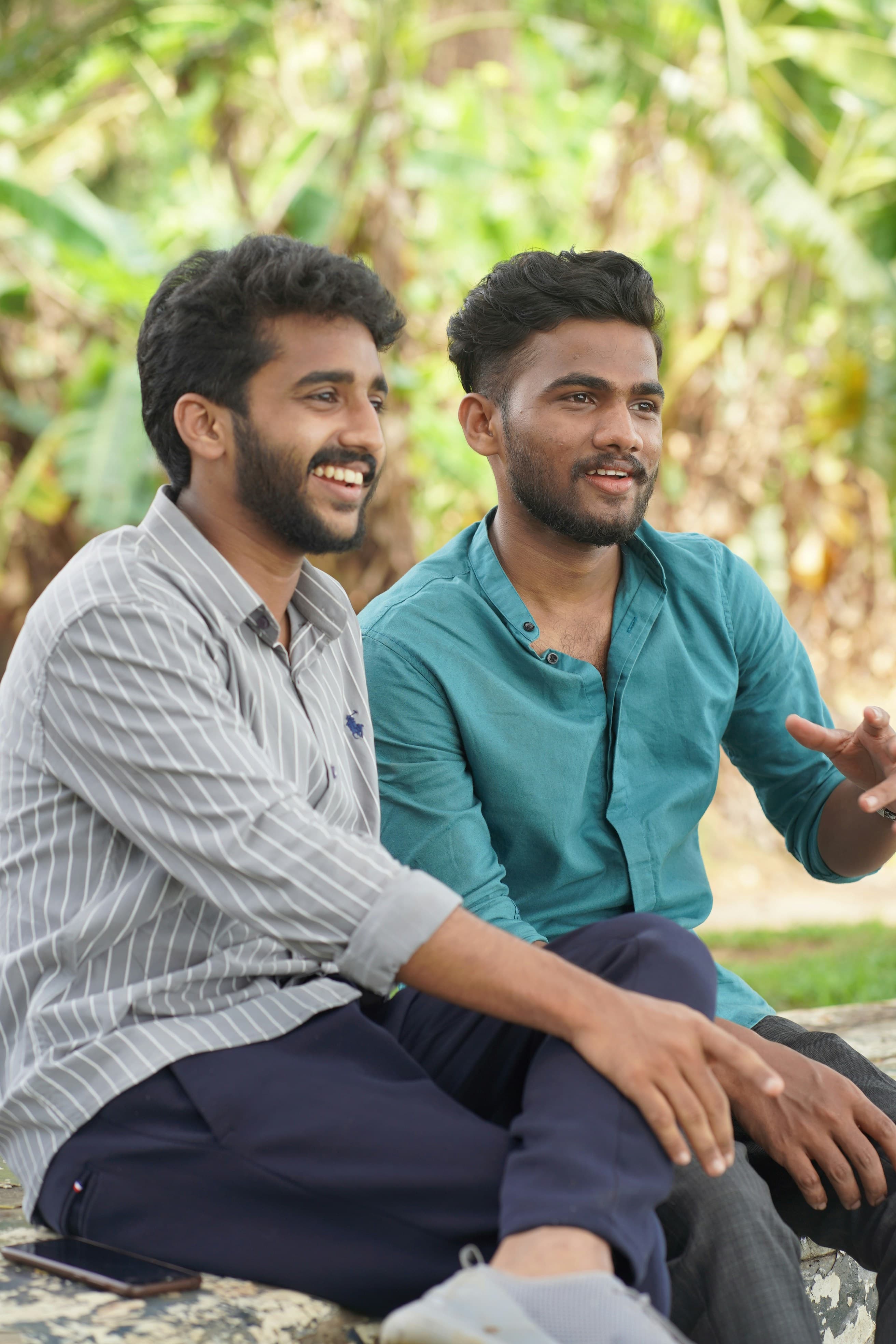 Two founders laughing in conversation outdoors