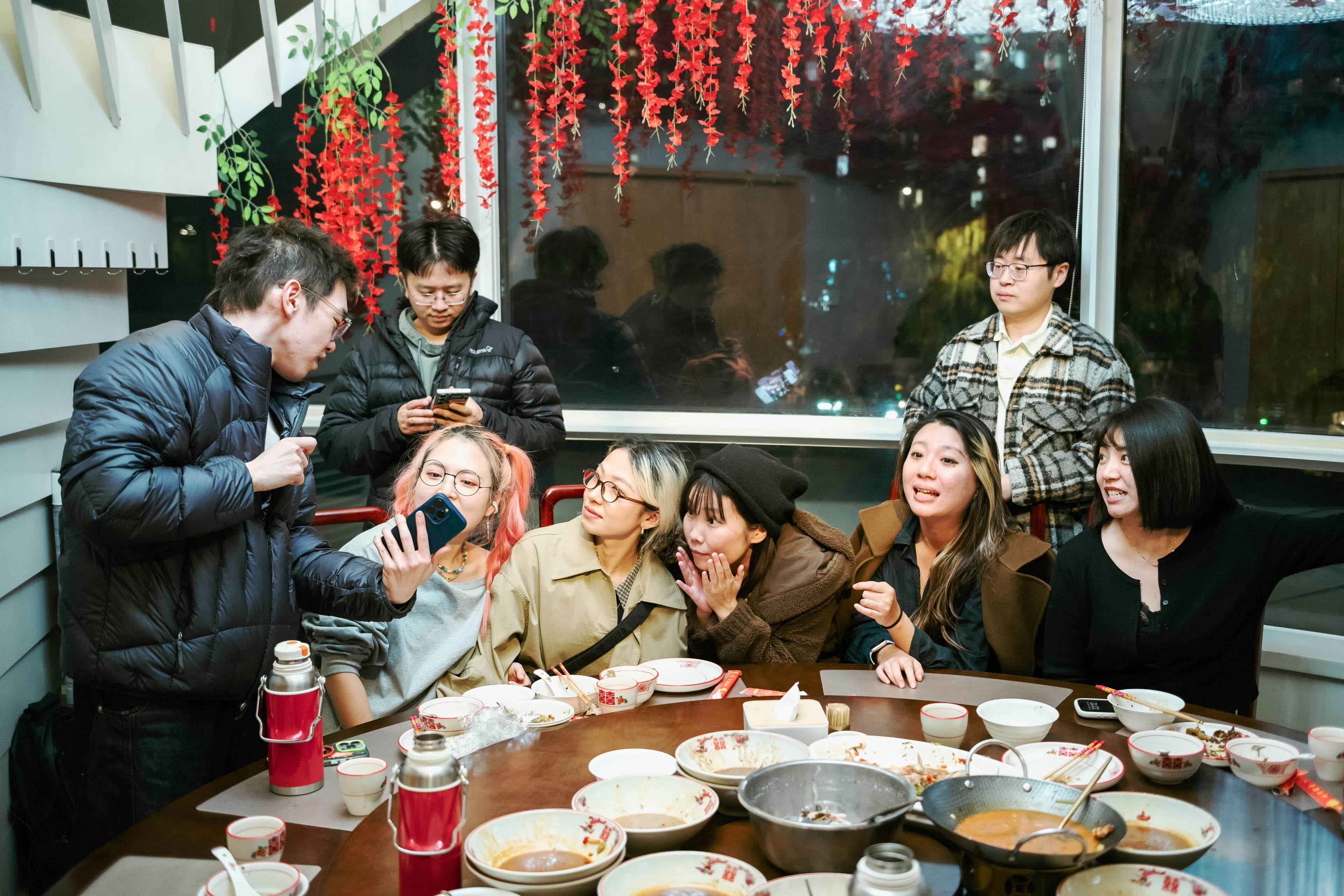 Friends gathered around a long table sharing a meal
